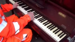 Workers at work run out of street piano